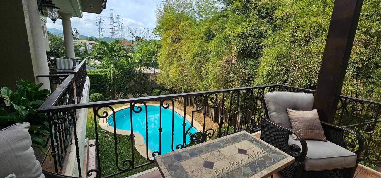 Private balcony overlooking the swimming pool and bamboo privacy screen