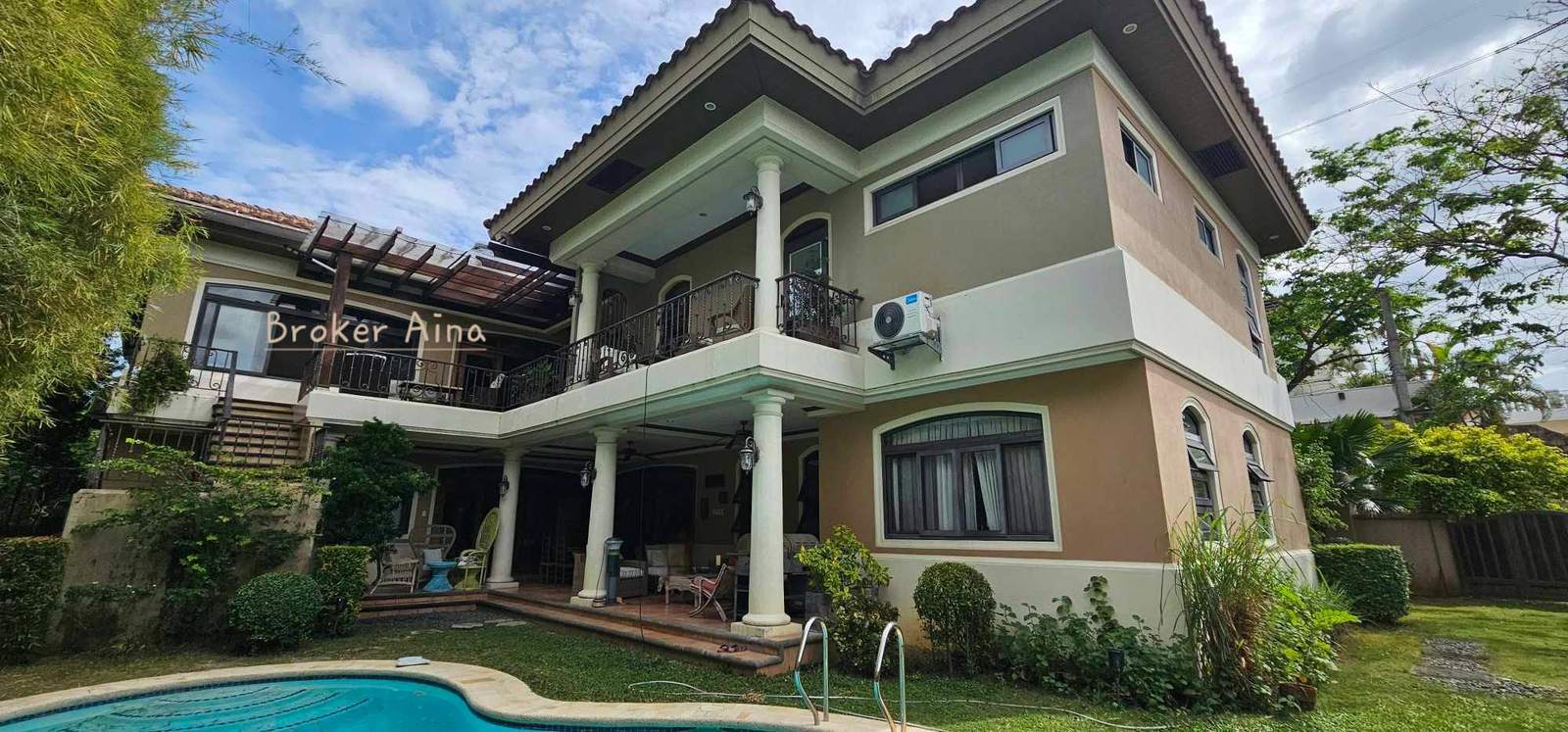 Rear elevation of the same premium North Town Homes residence revealing three levels, balconies and a swimming pool