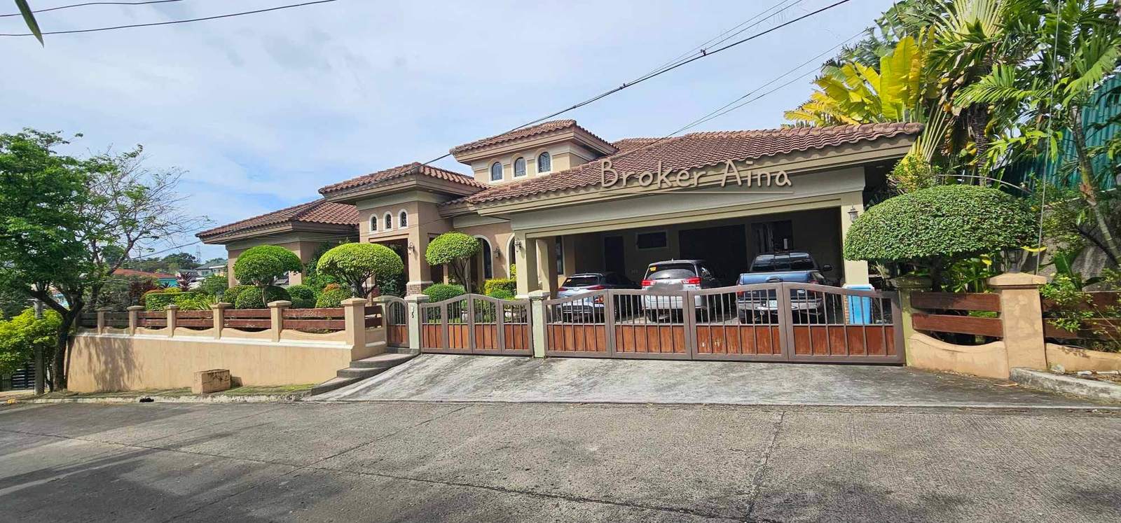 Street view of the luxury home for sale in North Town Homes, Mandaue City, presenting as a low-profile private bungalow behind a gated driveway